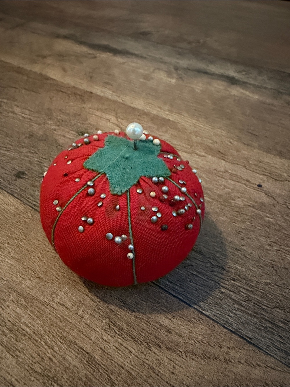 Vintage tomato pin cushions with pins